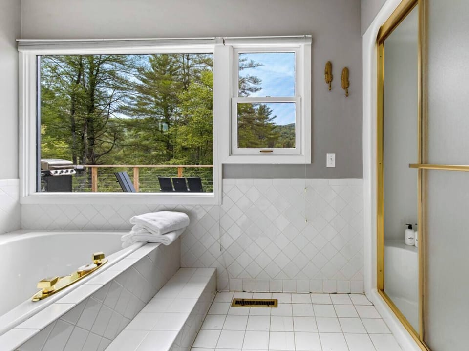 Master Bathroom with Jacuzzi Tub looking out over the hill and Steam sauna. 