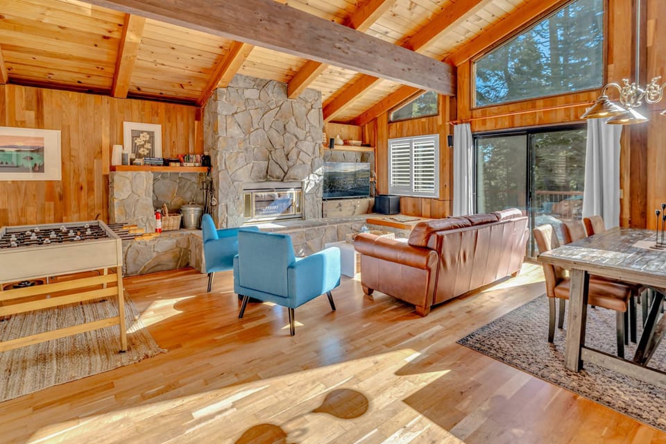 Living room: Main floor, wood-burning fireplace, Smart TV, foosball table, central heating, no A/C, access to deck