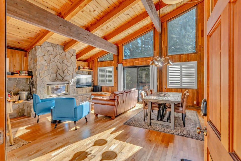 Living room: Main floor, wood-burning fireplace, Smart TV, foosball table, central heating, no A/C, access to deck