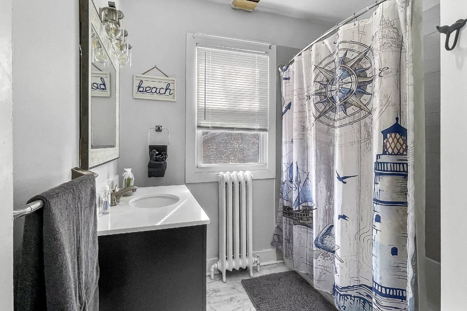 Full bath on first floor for guest use, next to first two guest bedroom