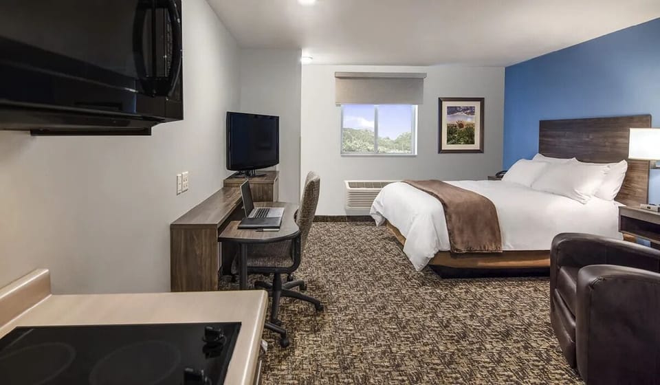 Unwind after adventures with cozy bedding and a productive workspace.