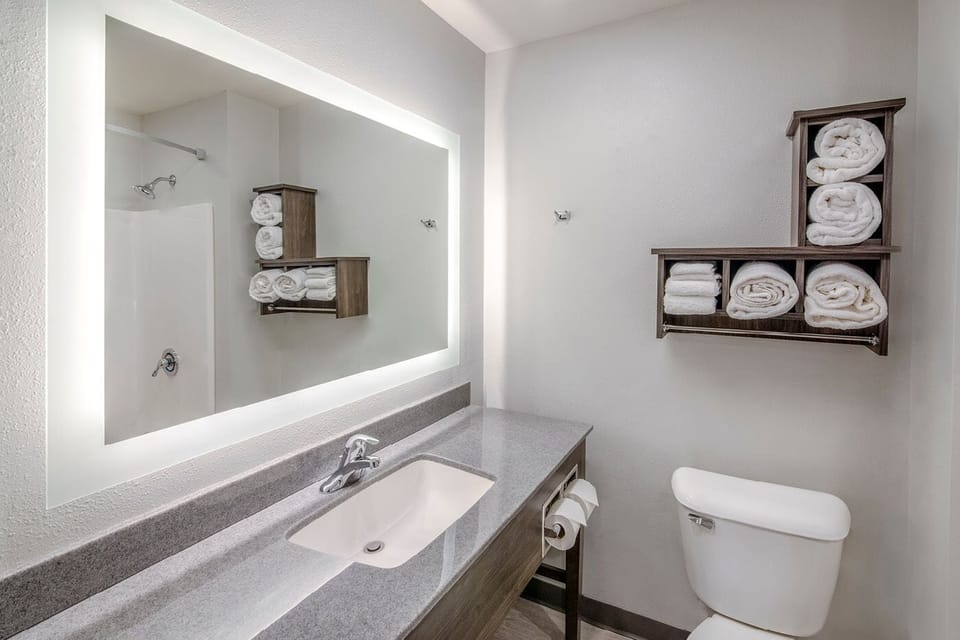 Refresh at the bright vanity with fluffy towels within reach.