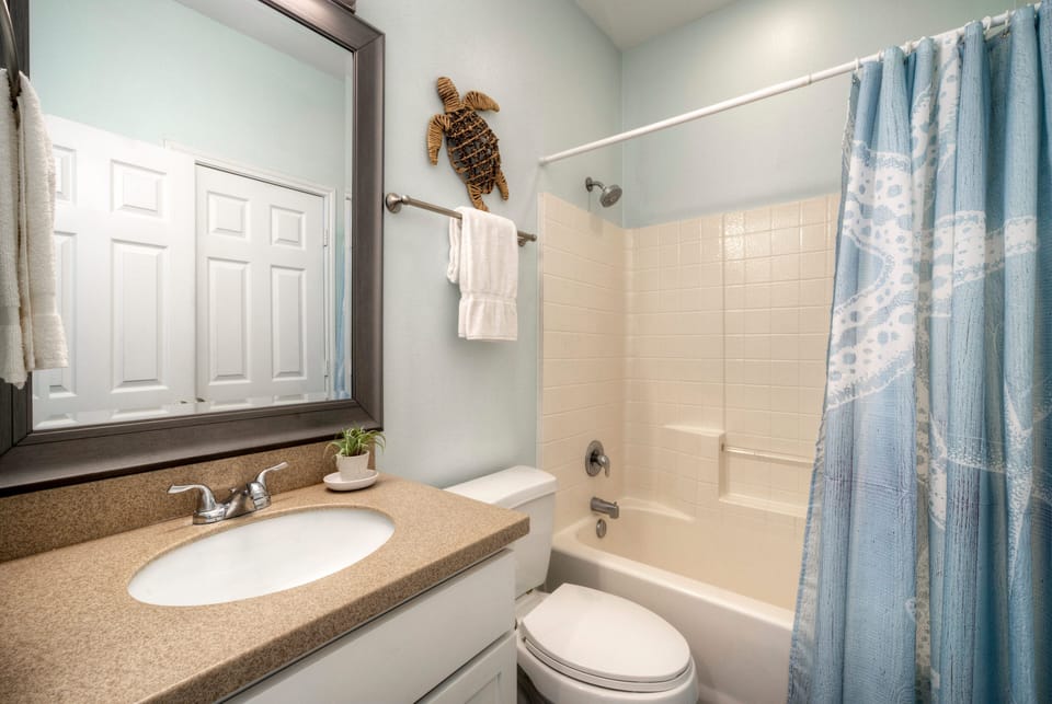 Ensuite bathroom 2 features a shower/tub combo. (Costa Bahia 207)