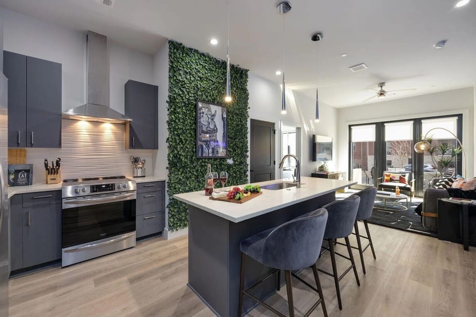 Spacious kitchen area featuring barstool seating at the counter, perfect for casual dining and socializing. (Nash Landing)