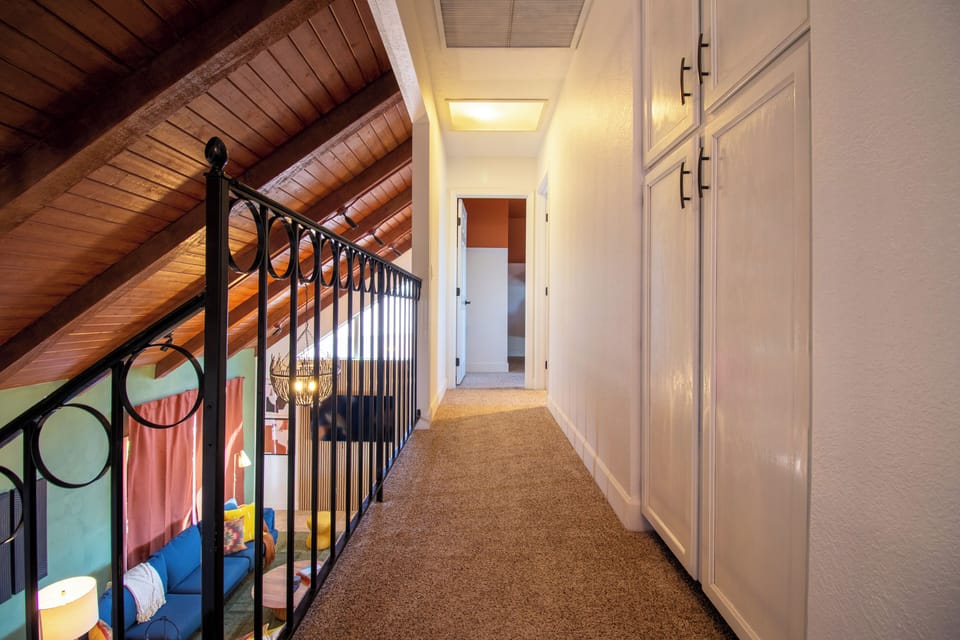 Upstairs hallway overlooking the large vaulted ceilings in the downstairs living