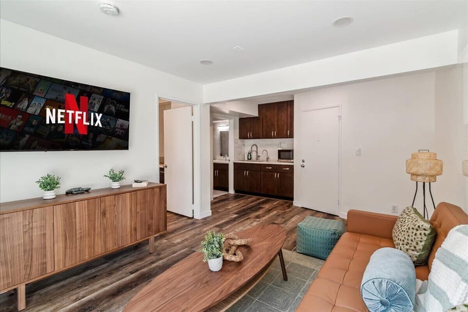 2nd downstairs living room with queen sized sleeper sofa, kitchenette, TV, and access to the large patio