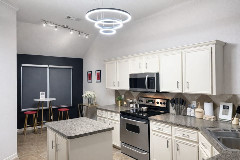 Fully equipped kitchen and bar seating for intimate meals.