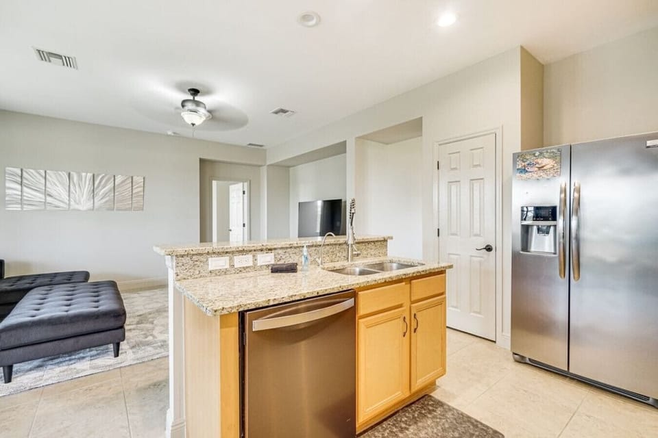 A spacious kitchen island with a sink and dishwasher makes meal prep and cleanup a breeze.