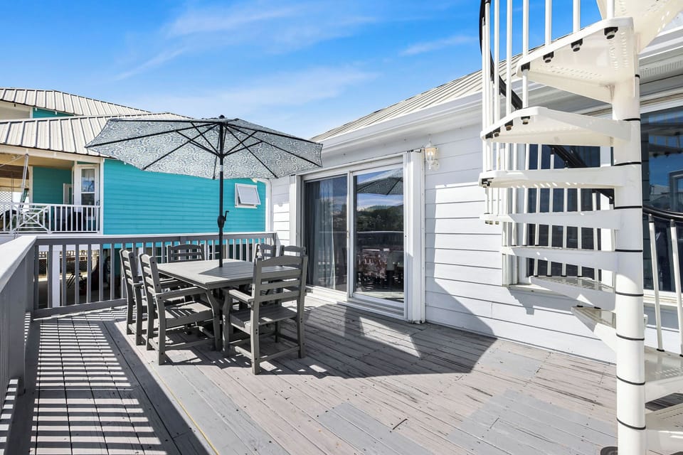 Outdoor dining, off primary suite. Spiral staircase leading up to top deck