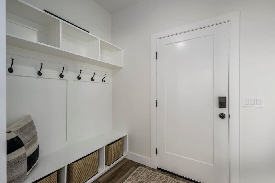 Mudroom with hooks and bench seating for easy organization.