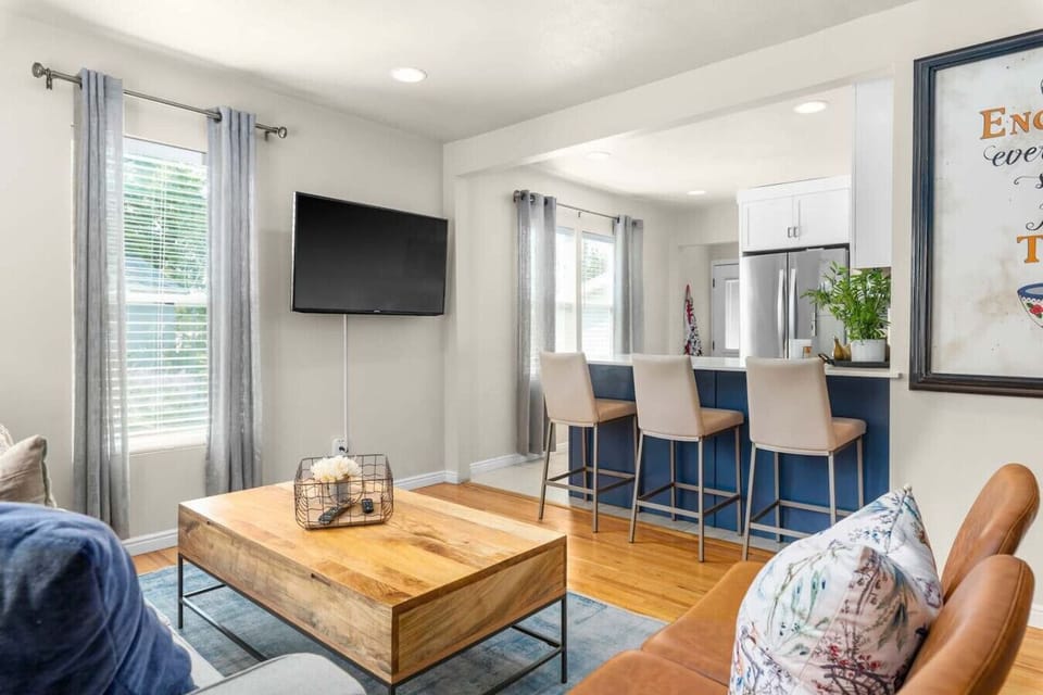Open concept living room connected to kitchen & dining