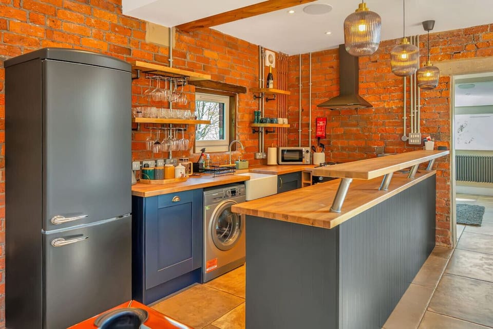 A stylish bar kitchen with oak worktops and crystal glasses ready for your celebration.