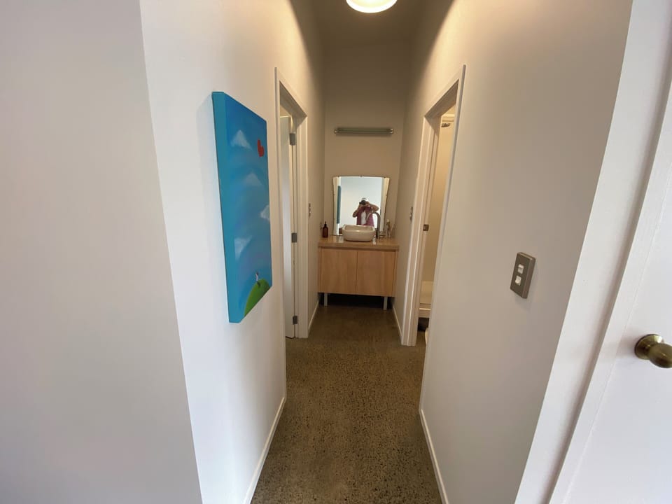 Hallway to vanity, laundry/toilet is on the left and shower room on the right

