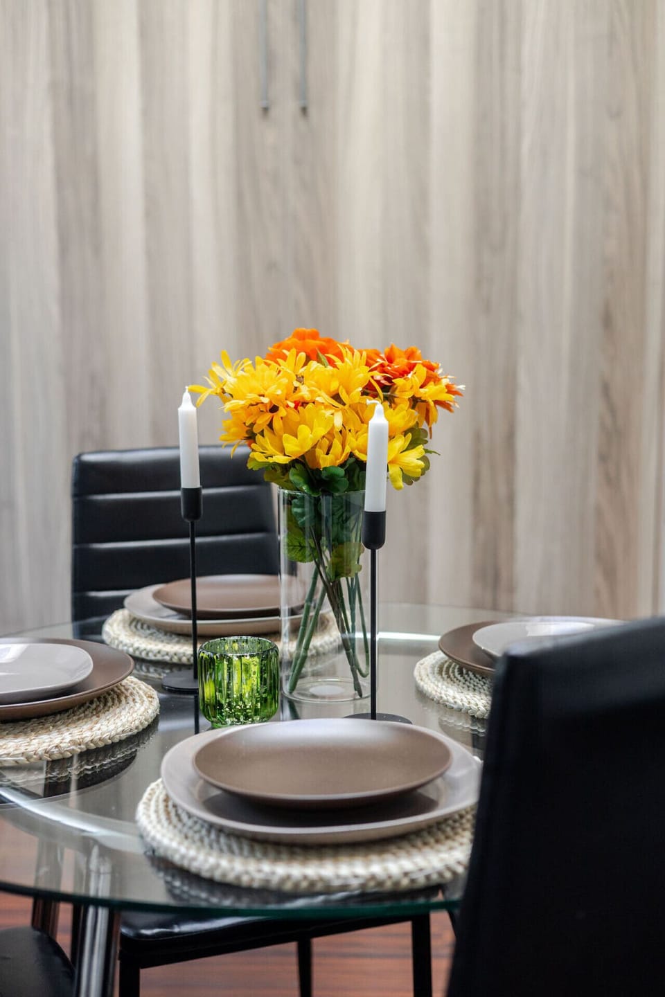 Chic dining setup with warm wood tones and a cheerful touch of florals