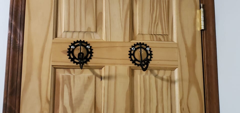 Bike parts make up the hooks on the back of the door in the Bike room