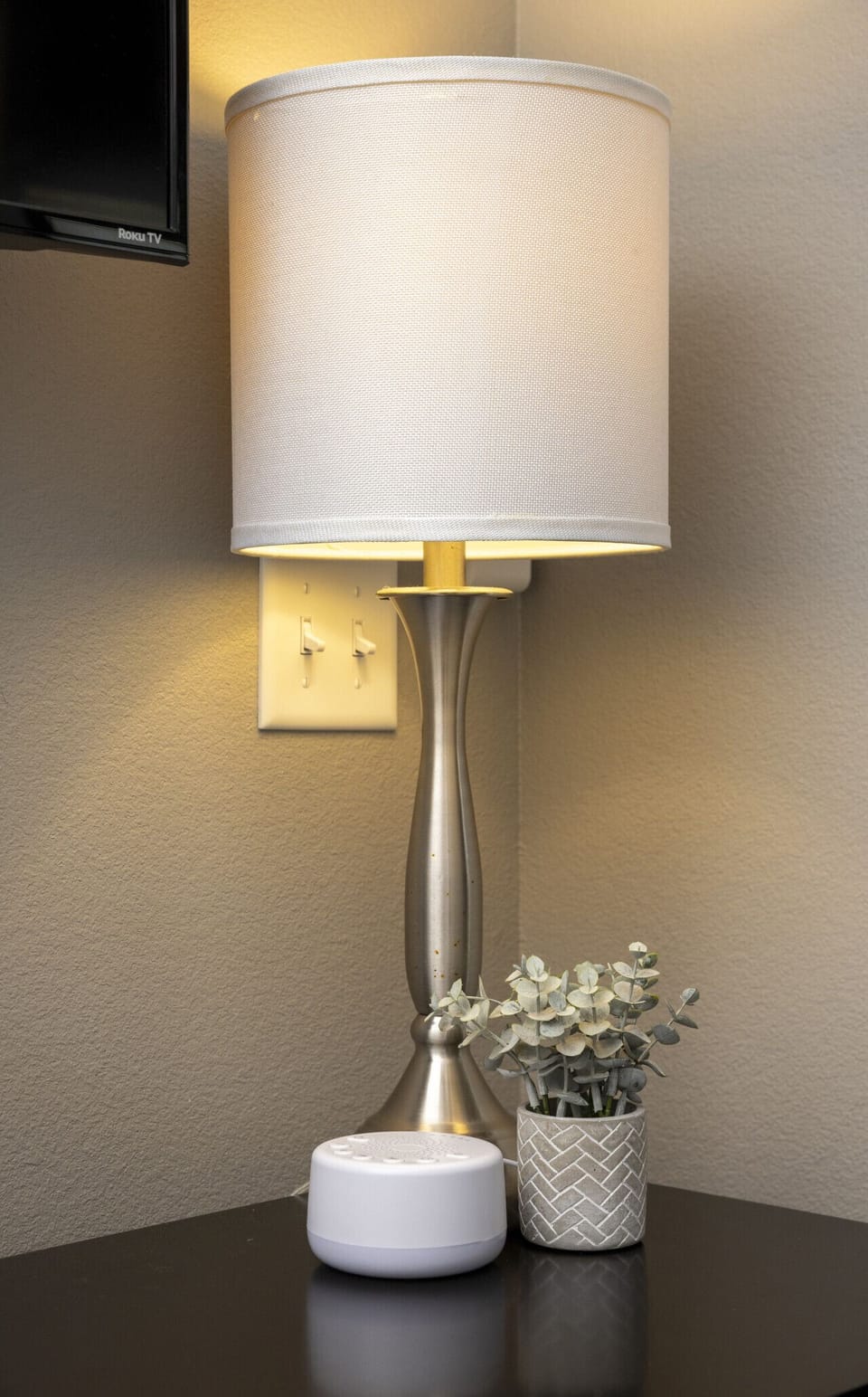 Soft, warm lighting from the bedside lampshade creates a cozy and relaxing ambiance for a restful night.