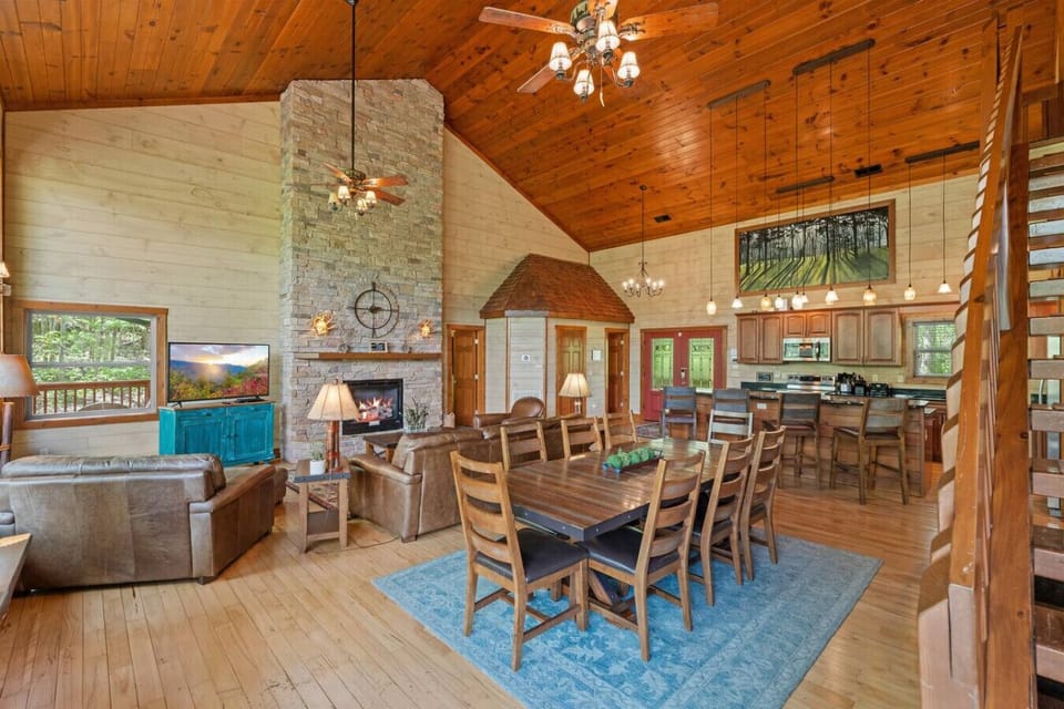 Enjoy meals, movies, and memories in this massive great room that seamlessly combines the living, dining, and kitchen areas—all framed by stunning Smoky Mountain scenery.