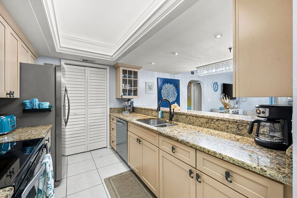 Completely updated and fully equipped kitchen at the entrance of this 2 BR 2 BA condo.