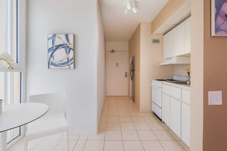 Bright kitchenette and dining area with modern touches — perfect for enjoying a meal with plenty of natural light streaming in.