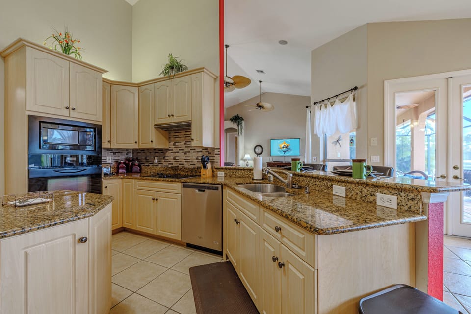 - Open concept kitchen with granite counters overlooks the spacious living and patio areas
- Stainless steel appliances and plenty of counter space make meal prep a breeze
- Perfect setup for entertaining while staying connected with guests