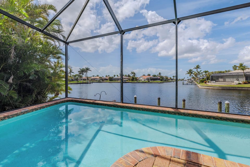 - Dive into the crystal clear waters of your private screened pool surrounded by greenery
- Marvel at peaceful canal views stretching out under the sunny Florida sky
- Perfect spot for refreshing swims, relaxing afternoons, and unforgettable memories