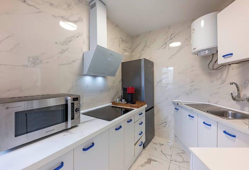 Kitchen: Fully equipped kitchen with appliances and washer, ideal for long stays. (1)