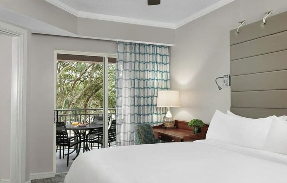 Primary bedroom w/access to the balcony. TV, of course.