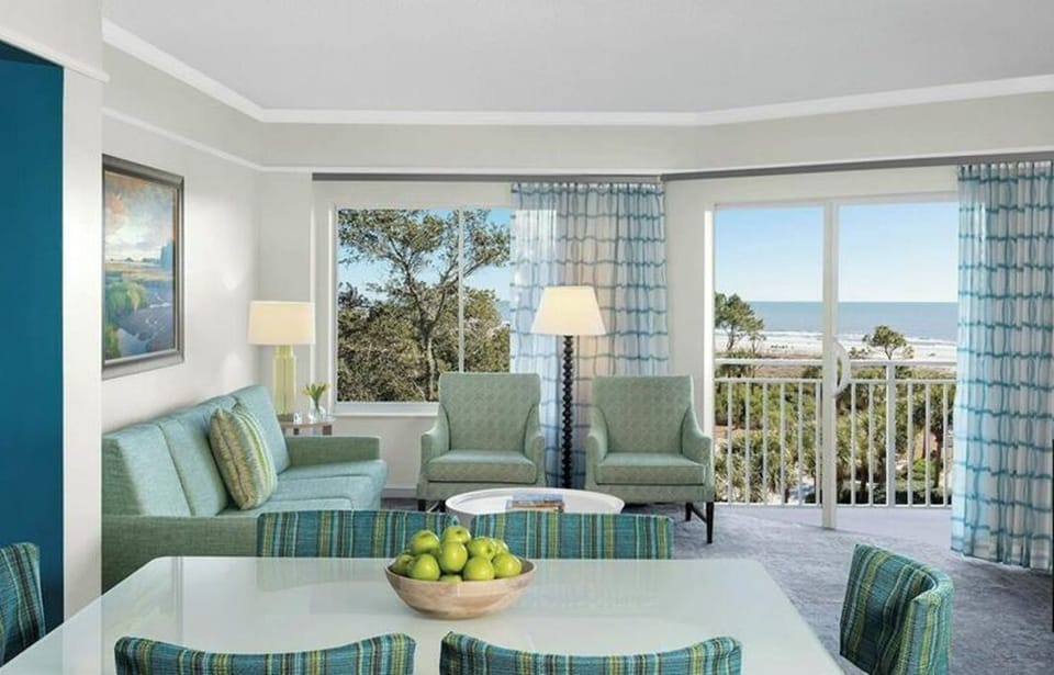 Living room and balcony (perfect for a.m. java & evening dining). Lg-screen TV.