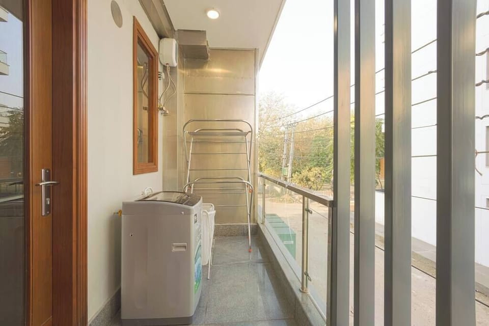 "Captivating Balcony Views: Gaze Upon a Scenic Landscape Featuring Lush Greenery, a City Skyline, and a Serene Ambiance at Parfait Street."