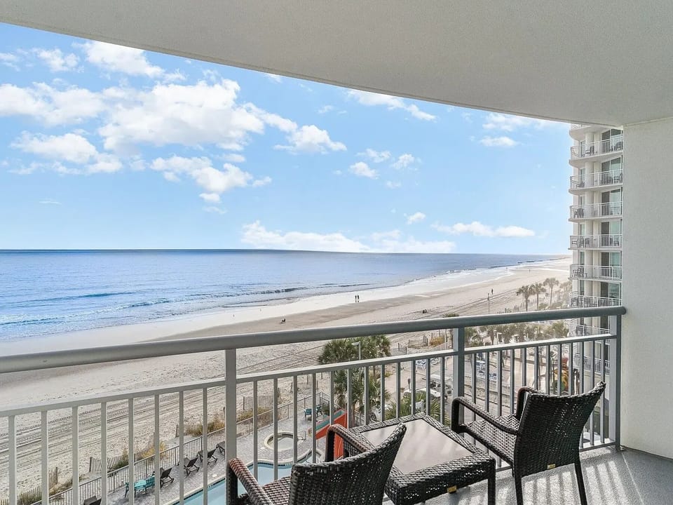 Oceanfront balcony seating area with breathtaking water views