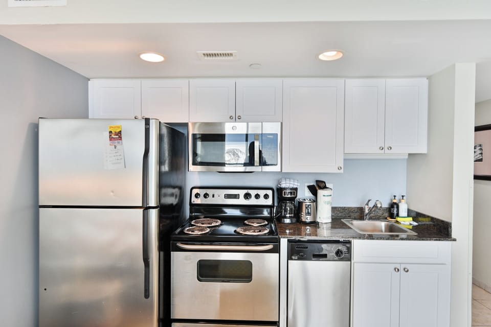 Fully equipped kitchen with stainless steel appliances.