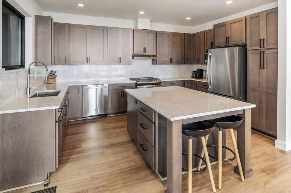 Well stocked kitchen with additional bar seating