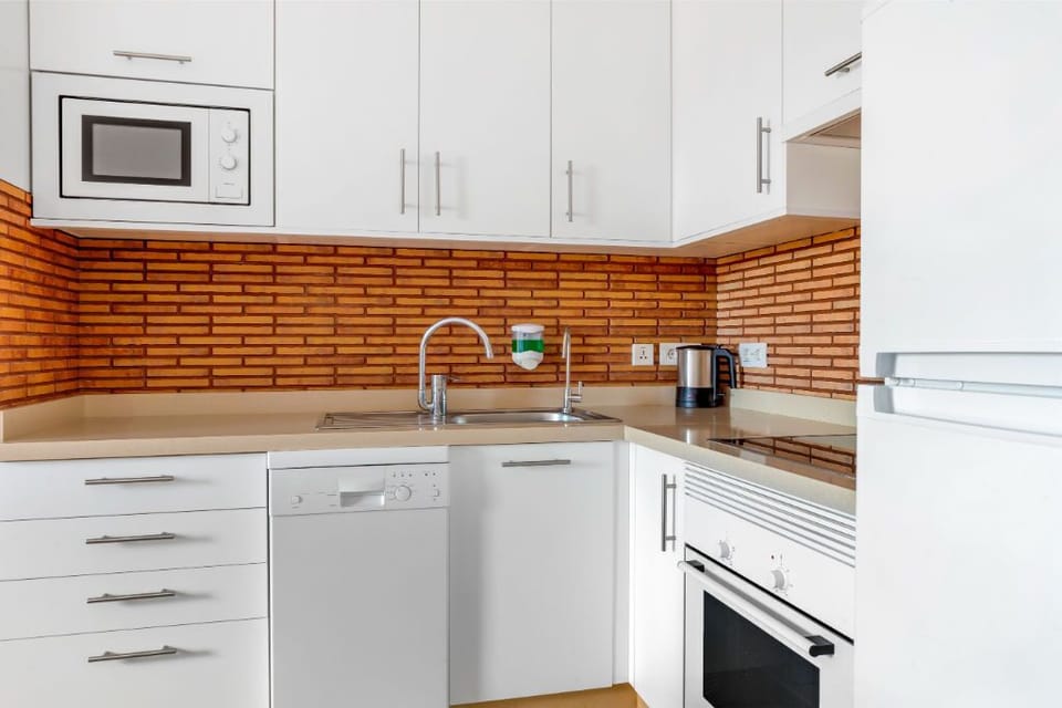 Charming kitchen with brick accents, combining classic touches with modern conveniences.