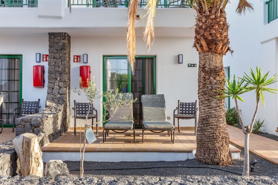 Chic decor meets tropical elegance in this welcoming outdoor lounge area.