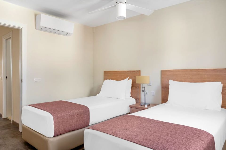 Twin bedroom setup, ideal for sharing and still having personal space.