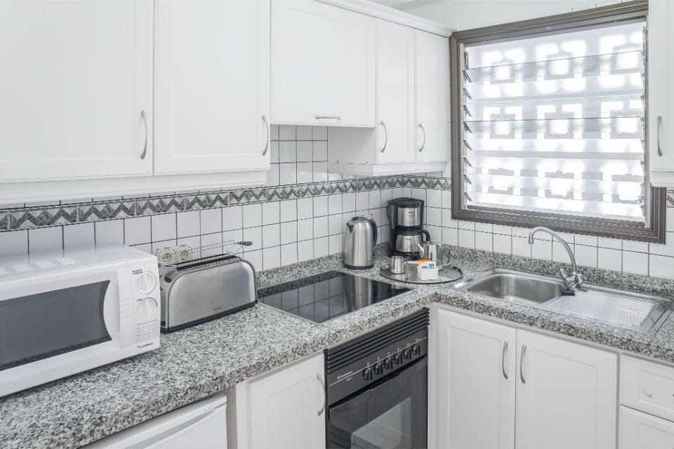 Kitchen space with essential appliances, good for preparing simple meals.