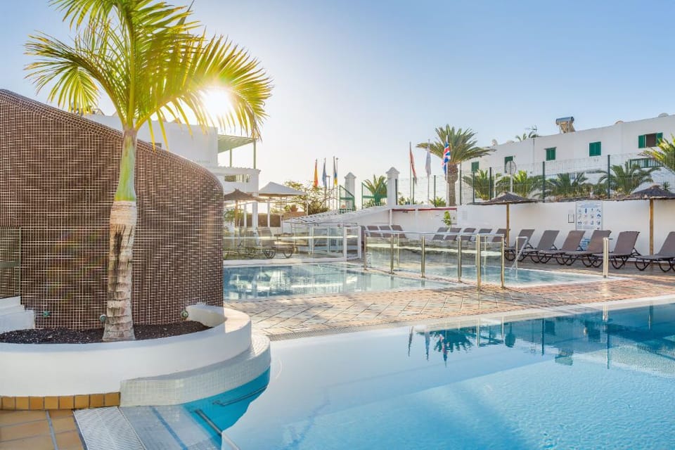 Lounge under the palms by our serene poolside, your oasis of tranquility.