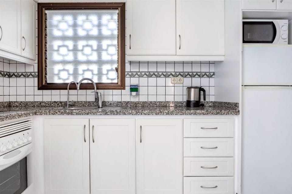 Kitchen setup that includes the essentials for preparing meals and snacks.