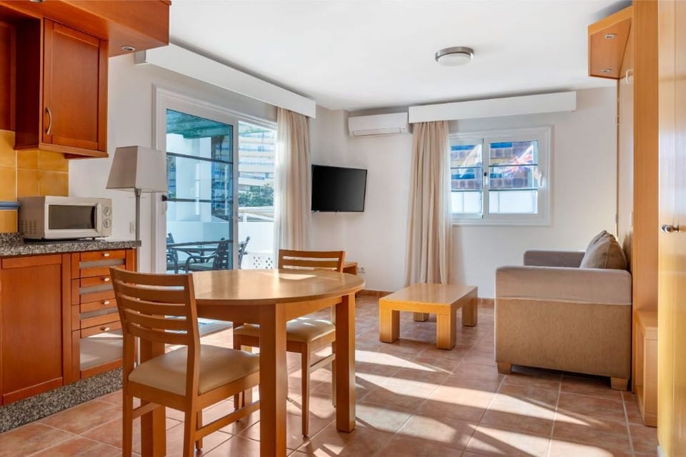 Dining area adjacent to the living room, suitable for meals and gatherings.