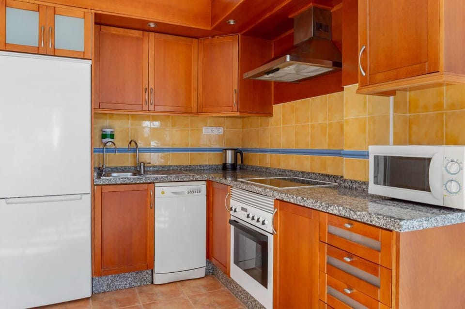 Kitchen space with essential appliances for convenient meal preparations.