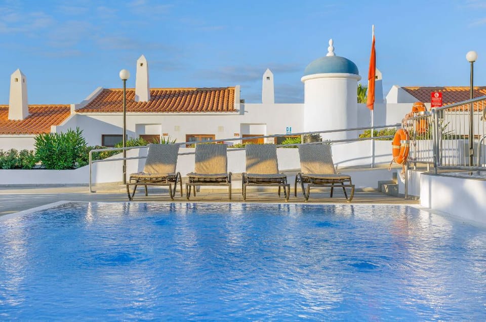 Central pool area with loungers and parasols.