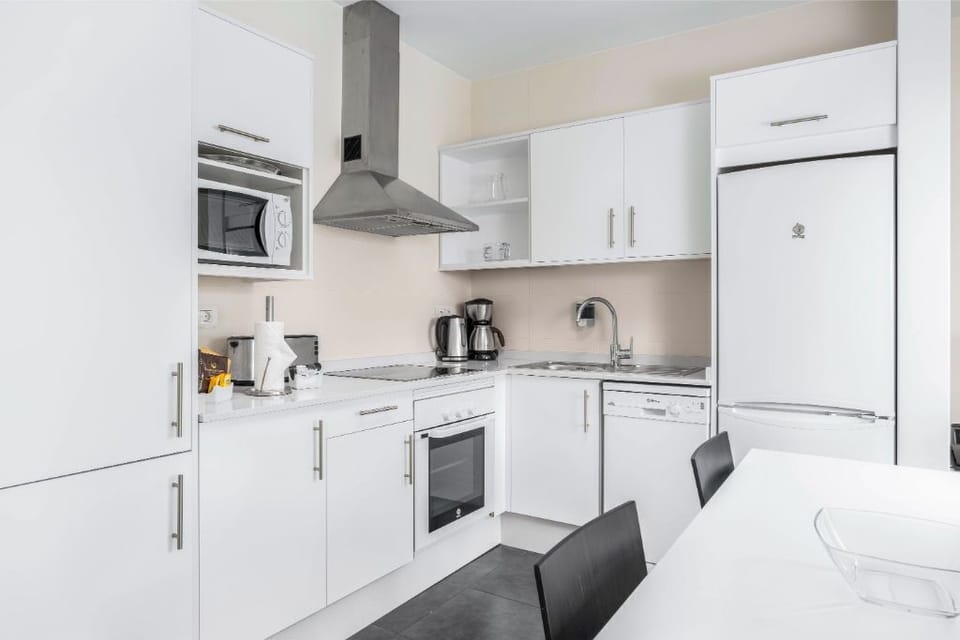 Sleek kitchen space with modern appliances.