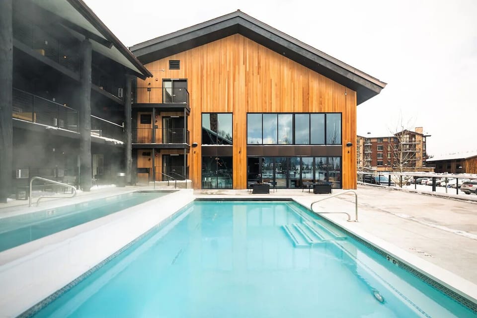 Dive into crisp turquoise water beside modern alpine design.