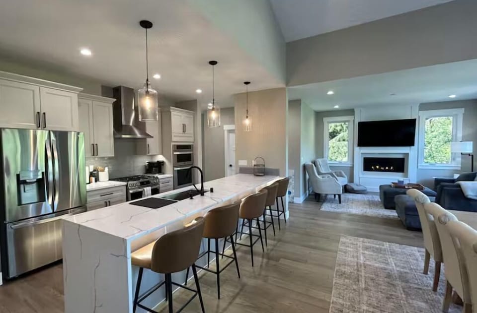 Spacious & open kitchen/dining/living. Sliding door to deck to right of table.