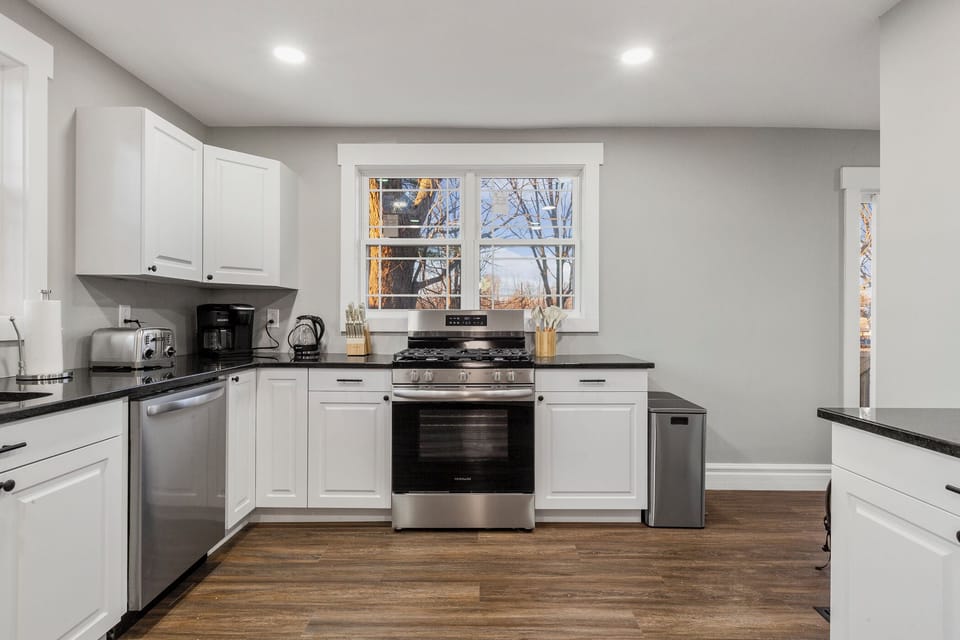 open, L shaped kitchen with lots of natural sunlight 