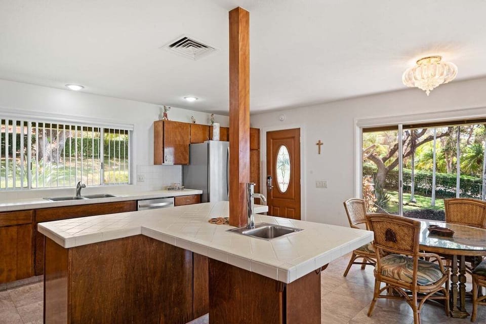 Experience indoor-outdoor living with a stylish kitchen and dining nook.