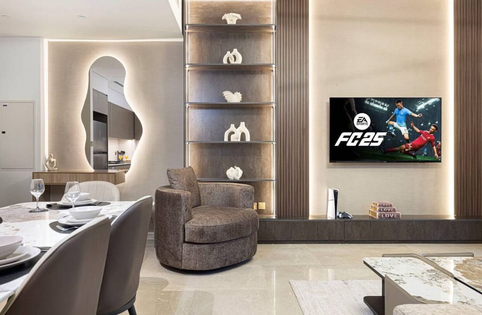 Enjoy a beautifully decorated living room featuring modern furnishings and elegant décor, seamlessly connected to a stylish dining table. This open-concept space offers comfort and sophistication for your luxurious stay in Downtown Dubai.