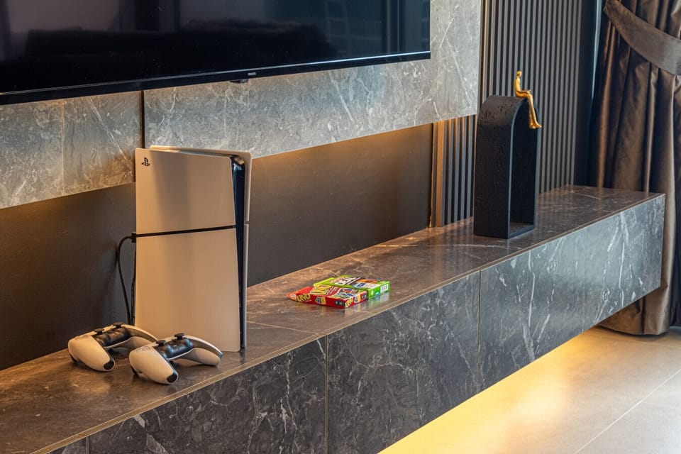 A PlayStation console beside a set of card games, perfect for a fun and relaxed entertainment experience. Ideal for gaming or enjoying casual games with friends.
