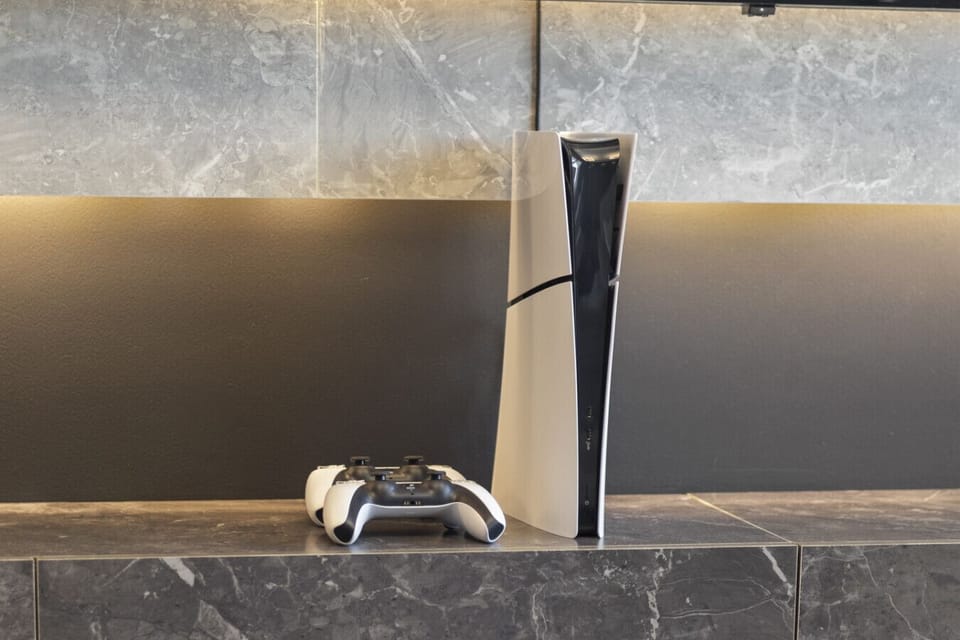 A sleek PlayStation console positioned neatly in the living room, perfect for gaming sessions, paired with stylish decor for a modern, cozy atmosphere.
