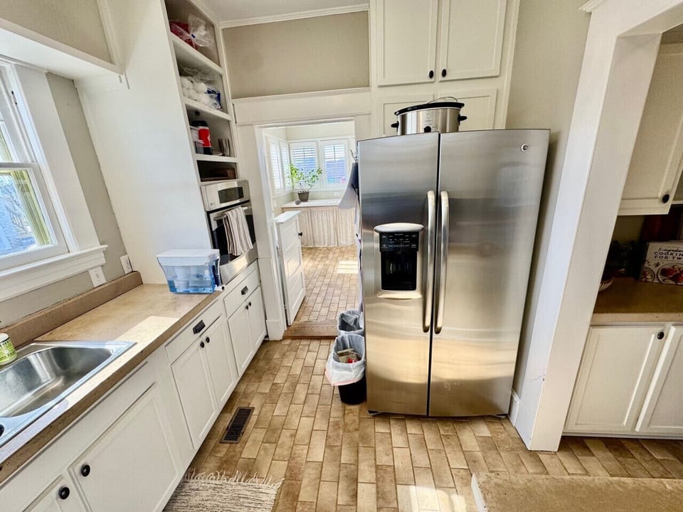 Full kitchen with comfortable sitting area and access to dining room as well as back patio.